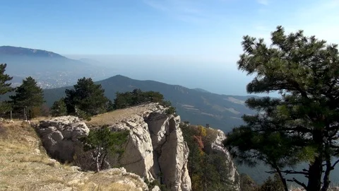 View of rock hanging over precipice from horizontal plateau of Mount Ai-Petri. Stock Footage 106774880