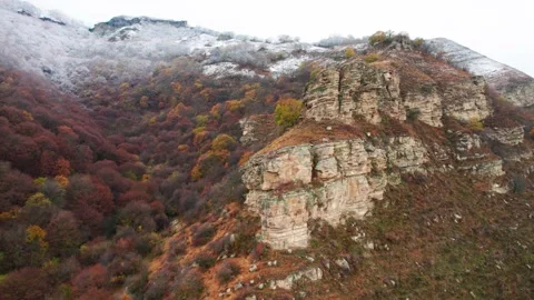 View of the rock illuminated by the rays of sunset and the peaks of the moun Stock Footage 170731050