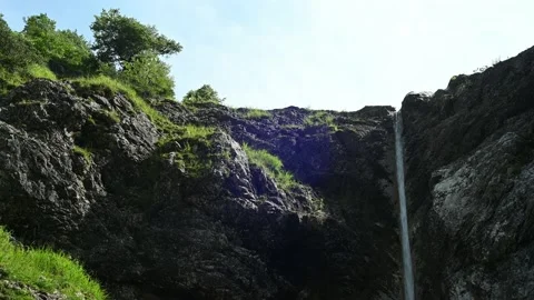 View on rocks and a beautiful waterfall in the mountains Video stock 211586565