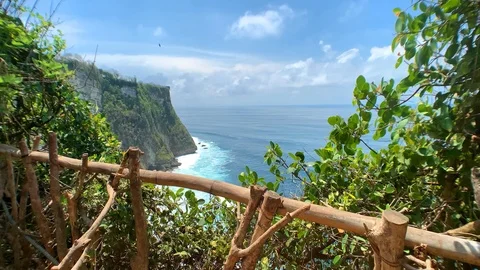 View of the rocks, the clear turquoise ocean and the waves forming a white foam. Stock Footage 122125890