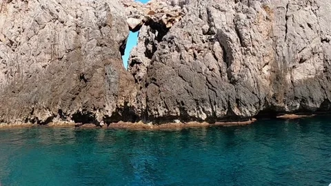 View on rocks with hole and deep blue sea at Mallorca Stock Footage 199871364