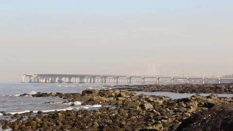 View from rocky beach of bridge over the sea in Goa, India Stock-Footage 276833863
