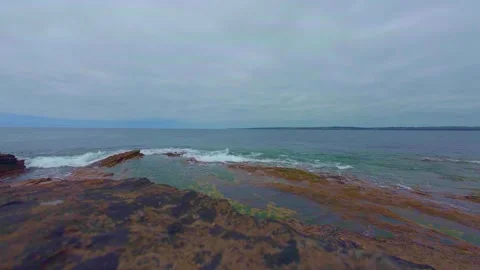 View of rocky coastline under overcast sky and sea horizon Stock Footage 340450129