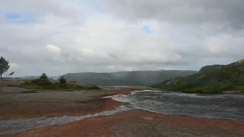 View of rocky landscape in Norway with cloudy skies and distant hills durin.. Stock Footage 340213600
