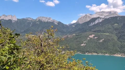 View of Rocky mountain tops over Lake Annecy France Stockbeeldmateriaal 342448706