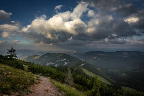 View on rocky path through grassy rax plateau in the cloudy sunset Stock Photos