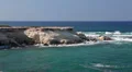 View at rocky seashore with caves in Pejia, Paphos, Cyprus HD Footage