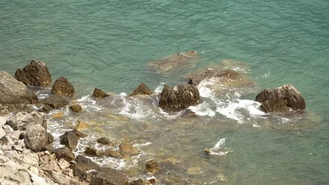 View of the rocky shore and the undulating sea Stock Footage 119224747
