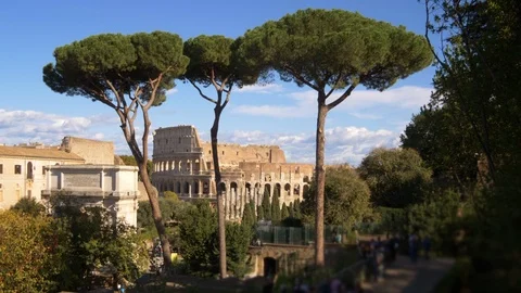 View of Roman Colosseum Through Trees in Rome, Italy (people blurred) 스톡 동영상 88190405
