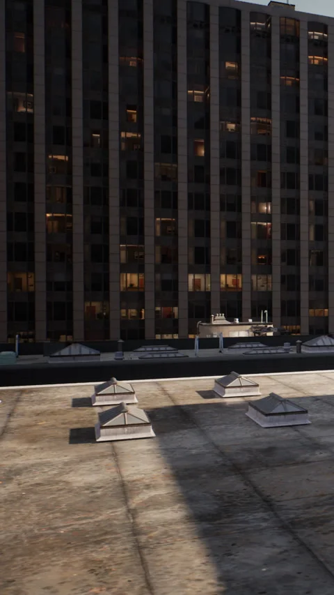 View of a rooftop with multiple skylights in an urban area during the evening Stock Footage 341243705