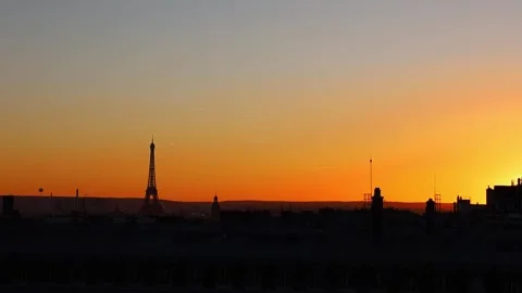 View of rooftops and Eiffel Tower with the sunset sky in Paris, France Stock Footage 299381047