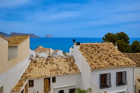 View of the rooftops and the sea from a high point of small old town with w.. Stock Photos