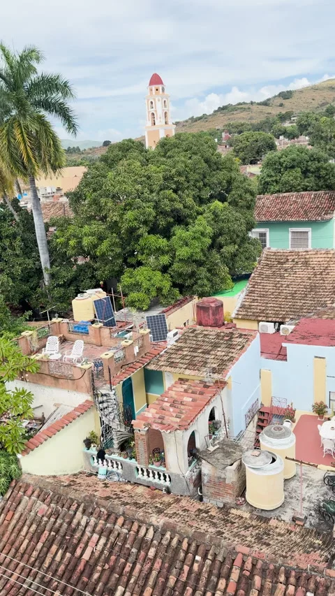 A view of rooftops in a Cuban town with colorful buildings Stock Footage 313275548