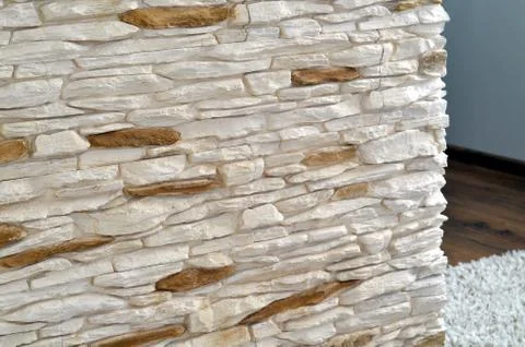 View into the room through a wall tiled rough stone cladding Stock Photos