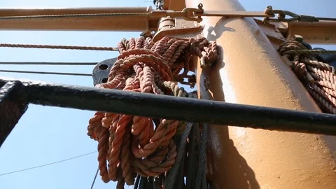 View of ropes hanging on the mast, elements of industrial ship, water transport Stock Footage 77375421
