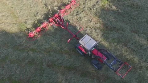 A view rotating over a tractor but following it (drone shot) Stock Footage 312275897