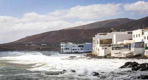 View of rough sea waves rolling on the coast in Arrieta, a small coastal town Stock Photos