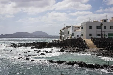 View of rough sea waves rolling on the coast in Arrieta, a small coastal town Stock Photos