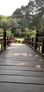 View of a rounded bridge in a park Stock Photos