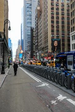 View of a row of electric bikes lined up along a New York City street Stock Photos