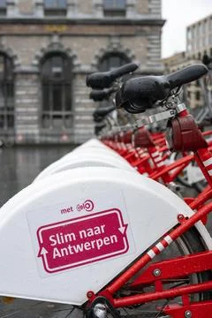 View of row of parked shared bicycles by Velo Antwerpen Stock Photos