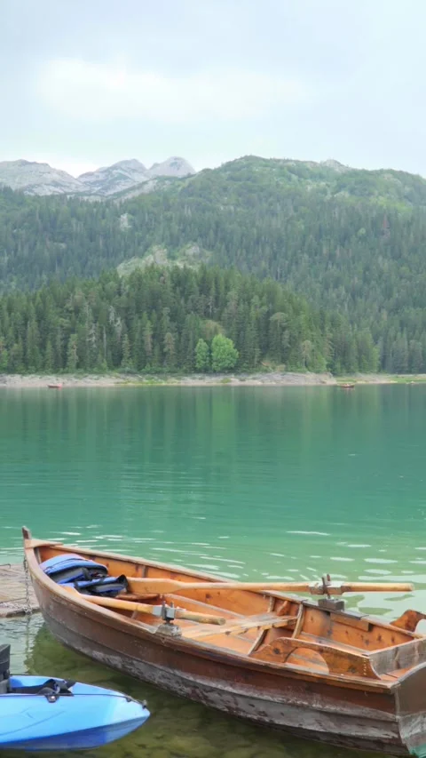 View of the rowing boat on the background of the Black lake in the mountains Stock Footage 281636619