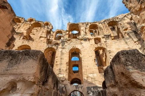 View to the rows of archs of the ancient african Roman Colosseum amphitheatre Stock Photos