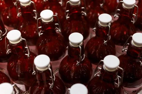 View of a Rows of Clear Red Bottles in a Factory Setting Stock Photos