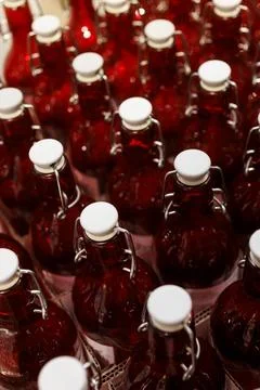 View of a Rows of Clear Red Bottles in a Factory Setting Stock Photos