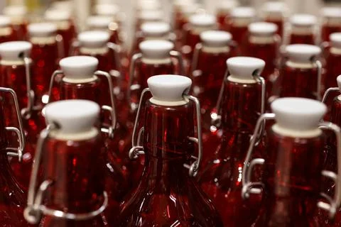 View of a Rows of Clear Red Bottles in a Factory Setting Stock Photos