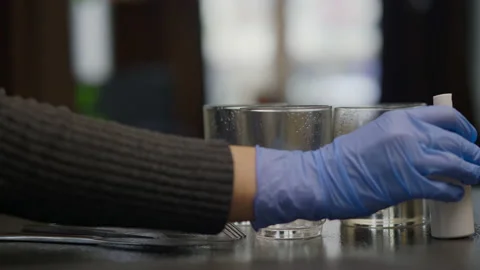View of rubber-gloved hands making disinfection of glasses and cutlery Stock Footage 147374192