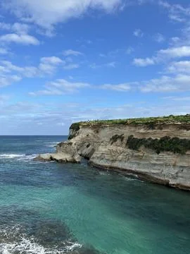 View of rugged limestone cliffs and clear turquoise sea Stock Photos