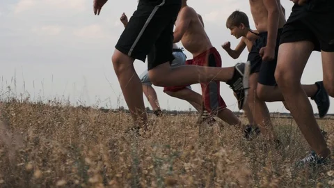 A view of running children, competing on a training in a field Stock Footage 93152139