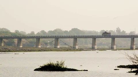 View Of A Rural Bridge On The River And Trucks And Cars Going On The Road.. Video stock 73850918