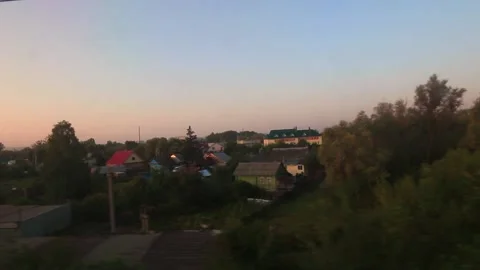 View of the Russian suburb from the train window on sunset Stock Footage 158012230