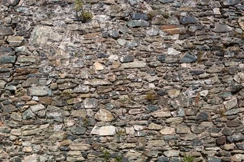 View of a rustic and old schist exterior wall, architectural textures Stock Photos
