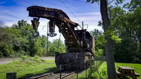 View of a Rusting of Train Steam Crane sitting on a Track Rusting Away Stock Photos
