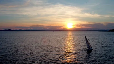 View of Sailboat Floating on Water by Sunset by Aerial Drone Stock Footage 86562435
