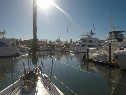View from sailboat as it moves through and out of the marina early morning Vídeos de archivo 79707363