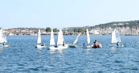 A view of sailboats Optimist learning to sail in Mediterranean 3 Stock Footage 113894826