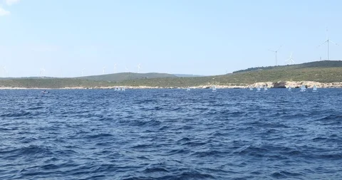 A view of sailboats Optimist learning to sail in Mediterranean Stock Footage 113896085
