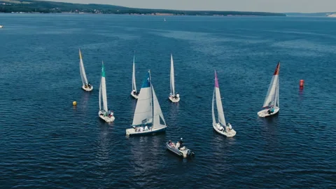 View of the sailing regatta from a height. backdrop of clear skies, green coast. Stock Footage 160472946