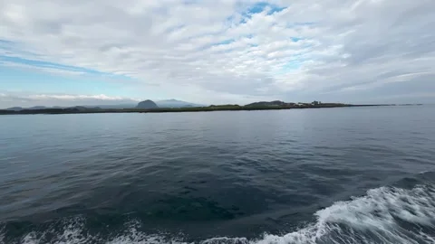 View from a sailing ship of sea and the Hallasan Mountain in the distant Stock Footage 276788817