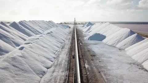 View of a salt flat factory besides the sea - Drone Shot of salt extraction Video stock 107138804