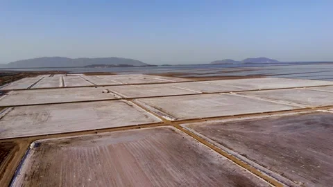 View of a salt flat factory besides the sea - Drone Shot of salt extraction Stock Footage 253283282