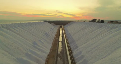 View of a salt flat factory besides the sea. Raw materials in large volumes are Видео 263067832