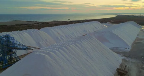 View of a salt flat factory besides the sea. Raw materials in large volumes are Stock Footage 265070239