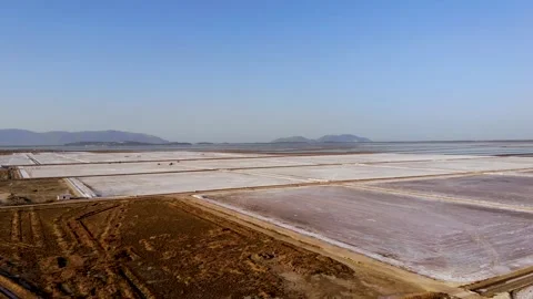 View of a salt flat factory besides the sea - Drone Shot of salt extraction Stock Footage 268880356