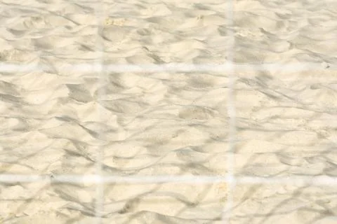 View of the sand on the beach through the protective grid. Stock Photos