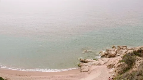 View on sandy beach and calm sea from top of cliffy mountain. Video stock 115712086